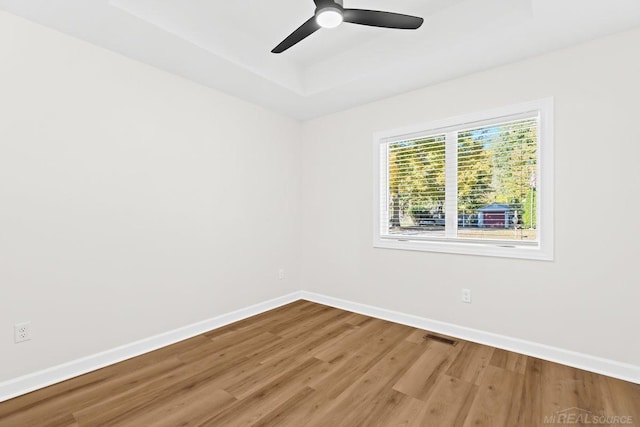 empty room featuring wood-type flooring and ceiling fan