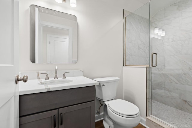 bathroom with vanity, toilet, and walk in shower