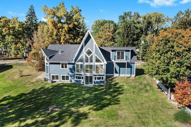 back of house featuring a yard and a sunroom