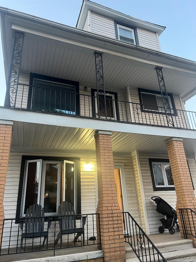 rear view of property featuring a balcony