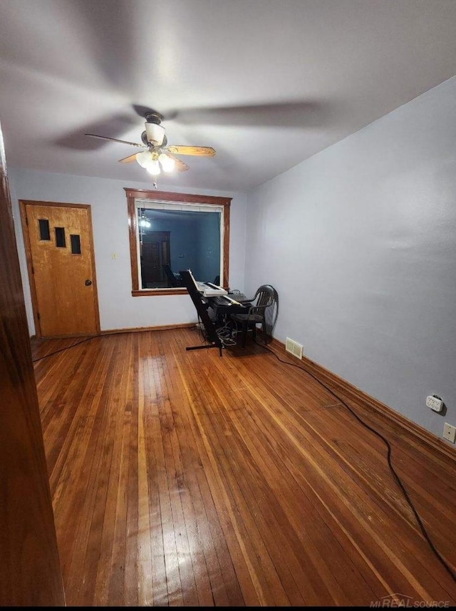 empty room featuring ceiling fan and hardwood / wood-style flooring