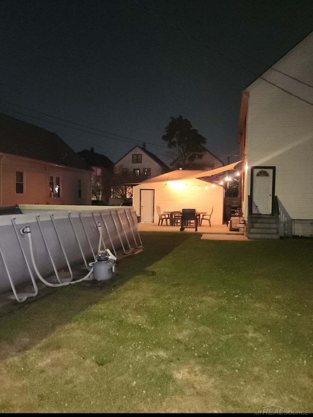 yard at twilight featuring a patio area