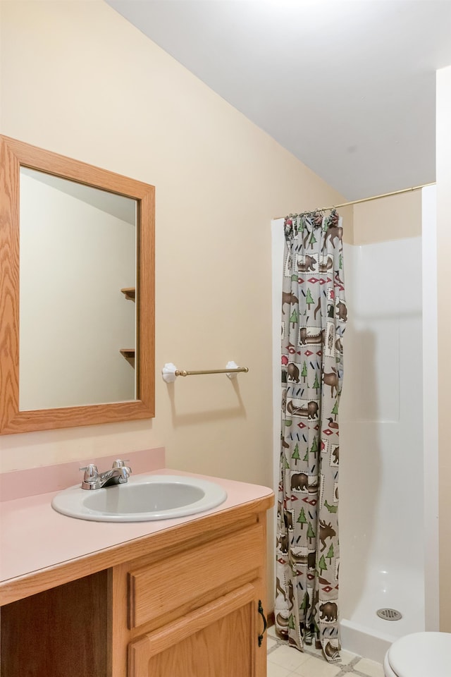 bathroom with vanity, a shower with shower curtain, toilet, and tile patterned flooring