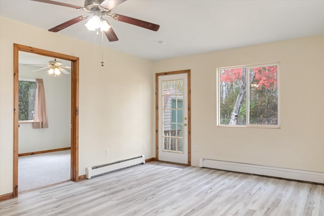 unfurnished room featuring light hardwood / wood-style flooring, a healthy amount of sunlight, and a baseboard radiator