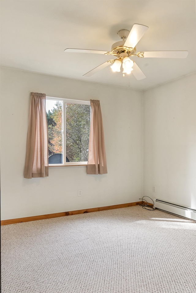 empty room featuring a baseboard heating unit, carpet floors, and ceiling fan