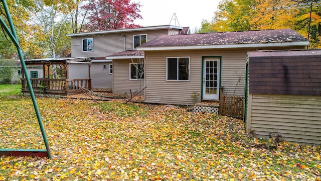 back of house with a yard and a deck