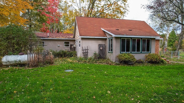 rear view of house with a lawn