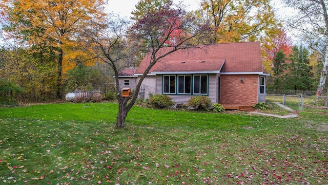 back of house with a lawn