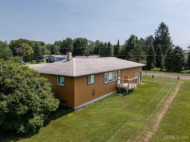 rear view of property with a lawn