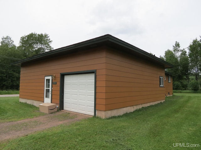 exterior space with wood walls and a lawn