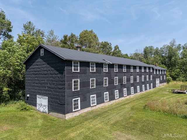 view of side of home featuring a yard