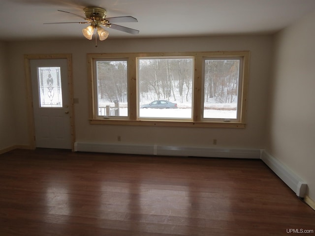 interior space with dark wood-type flooring and ceiling fan