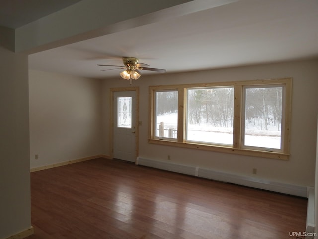 interior space featuring hardwood / wood-style floors, a baseboard heating unit, and ceiling fan