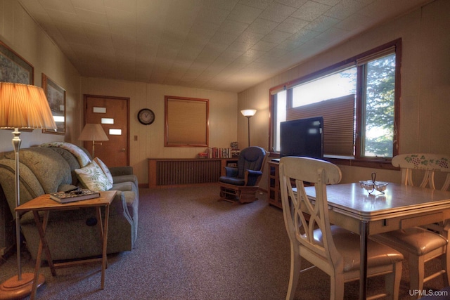 dining room featuring radiator heating unit and carpet flooring