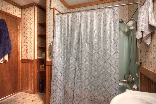 bathroom with tile patterned floors, curtained shower, and wood walls