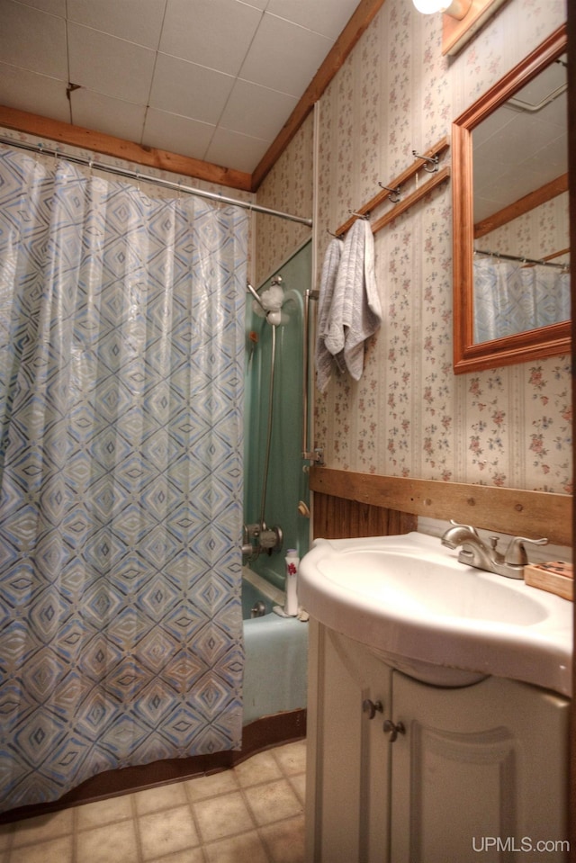 bathroom featuring vanity and shower / bathtub combination with curtain