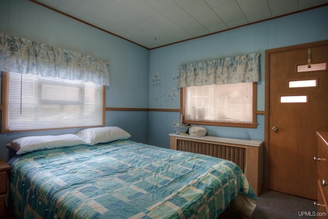 carpeted bedroom featuring radiator and ornamental molding