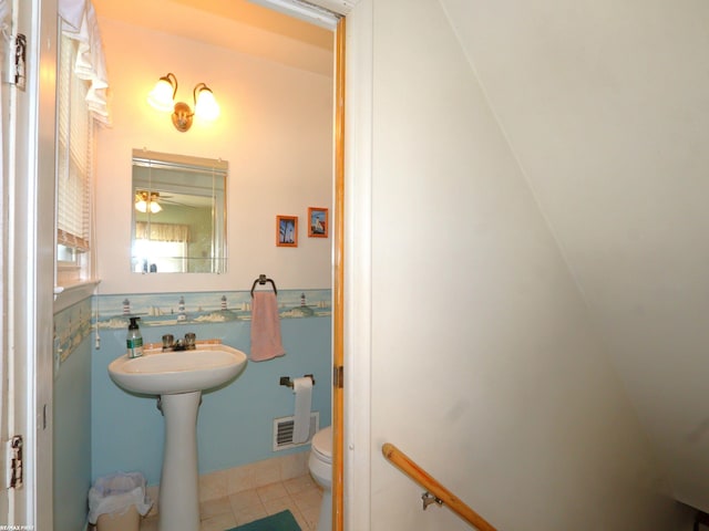 bathroom with toilet, sink, tile patterned flooring, and ceiling fan