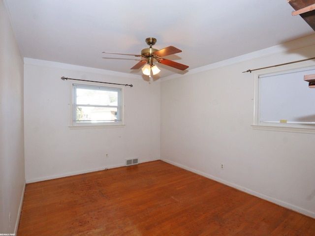 empty room with ceiling fan and hardwood / wood-style flooring