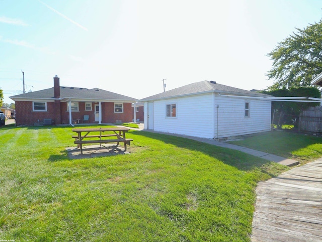 rear view of property with a yard