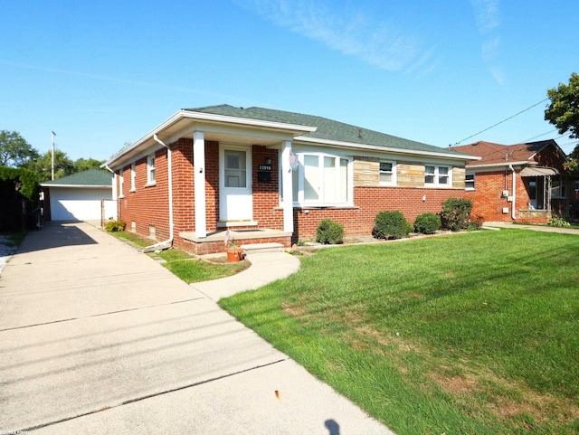 view of front of house with a front yard, an outbuilding, and a garage