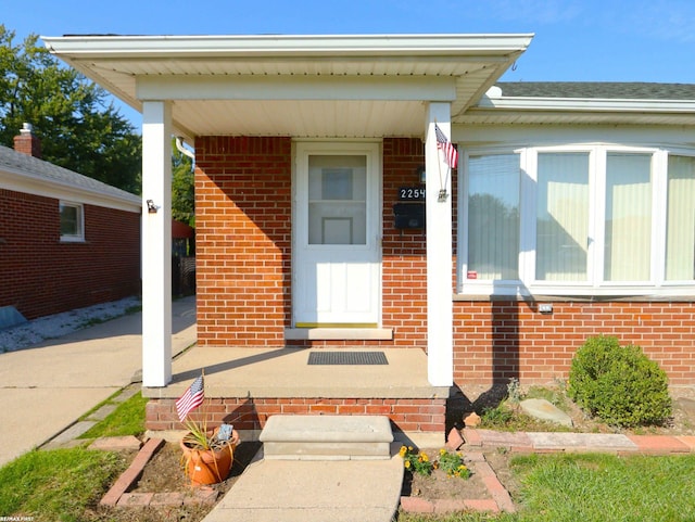 22549 Shorewood Dr, Saint Clair Shores, MI 48081 - doorway to property with brick siding and covered porch