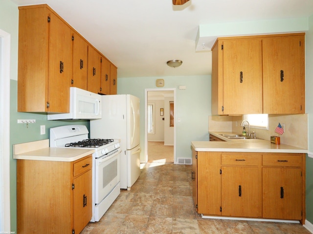 kitchen with white appliances and sink