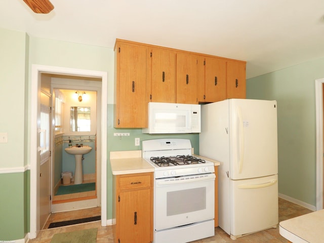 kitchen with sink and white appliances