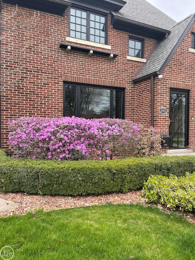 view of side of home with a yard