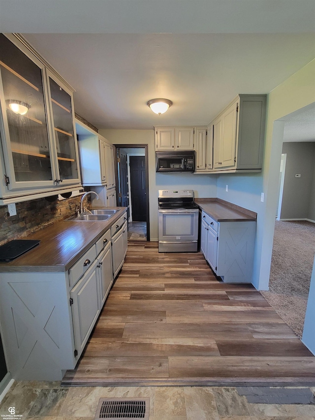 kitchen featuring dark hardwood / wood-style flooring, sink, and electric stove