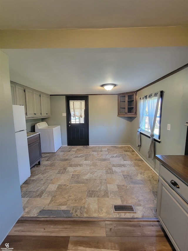 interior space with white fridge and independent washer and dryer