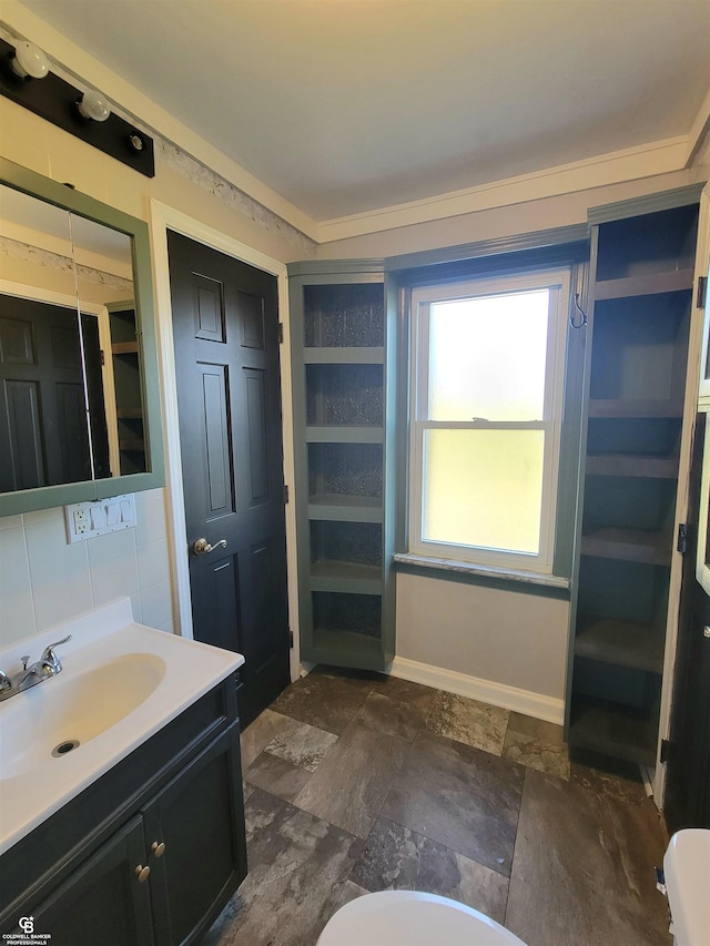 bathroom featuring vanity and decorative backsplash