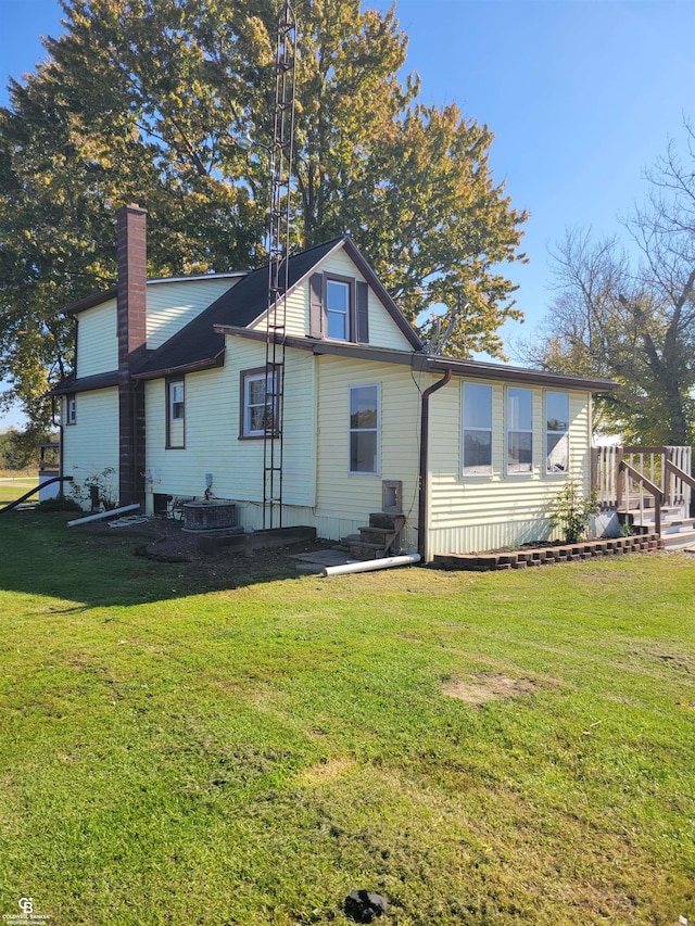 rear view of house featuring a yard