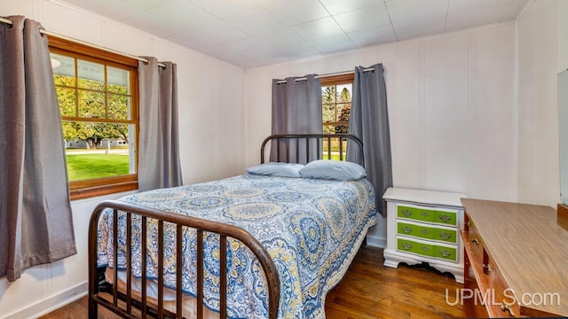 bedroom with dark wood-type flooring