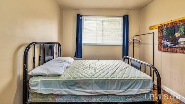 bedroom with wood-type flooring