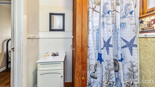 bathroom featuring vanity, hardwood / wood-style floors, and a shower with curtain