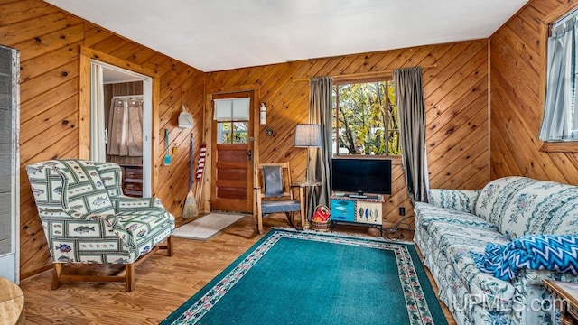 living room featuring hardwood / wood-style floors and wood walls