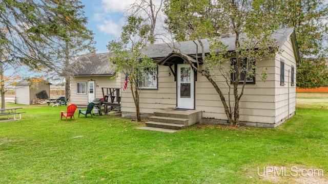 rear view of property with a lawn