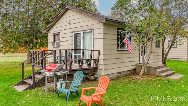 back of property with cooling unit and a lawn