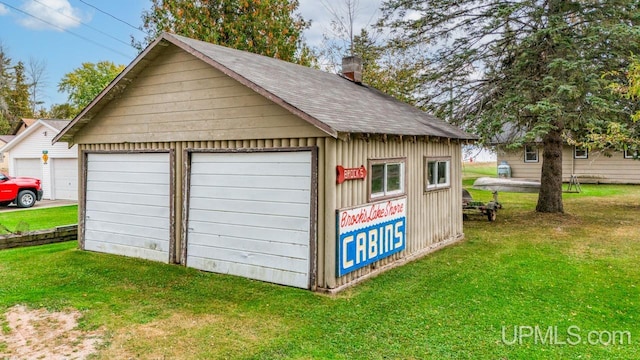 garage with wooden walls and a yard