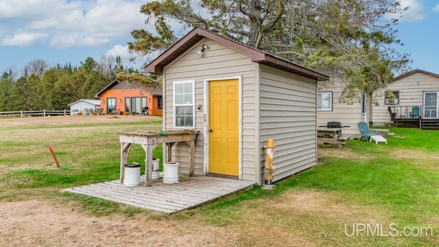 view of outdoor structure with a lawn