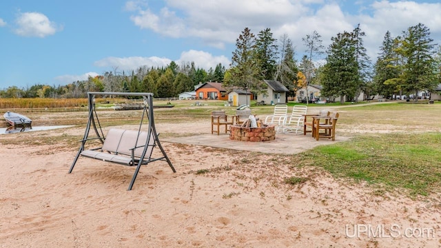 view of playground featuring an outdoor fire pit