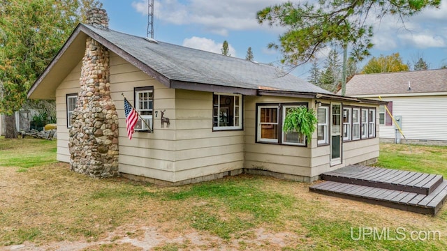 back of house with a lawn