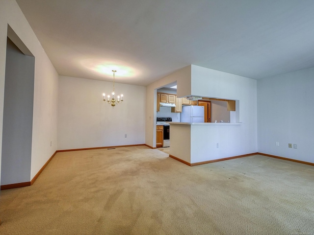 unfurnished living room with a notable chandelier and light colored carpet