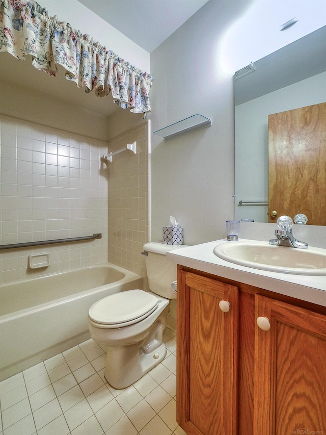 full bathroom featuring vanity, toilet, tile patterned floors, and tiled shower / bath