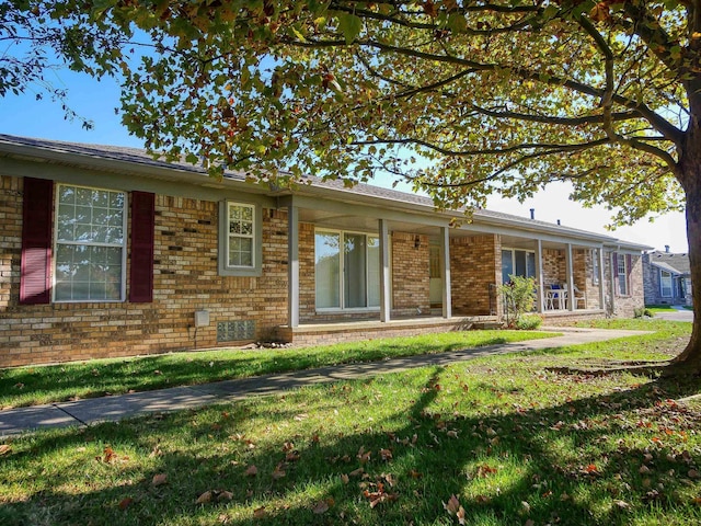 rear view of property with a lawn