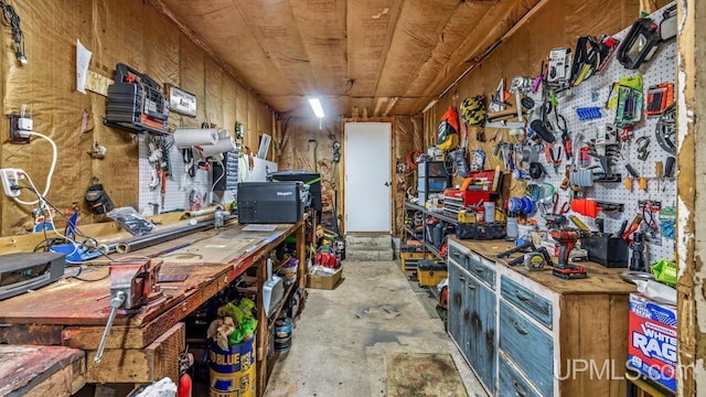 interior space with unfinished concrete floors and a workshop area