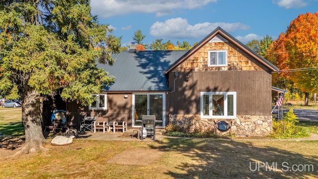 rear view of property featuring a patio area and a yard