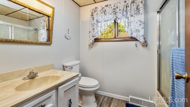 full bathroom featuring vanity, combined bath / shower with glass door, toilet, and wood-type flooring