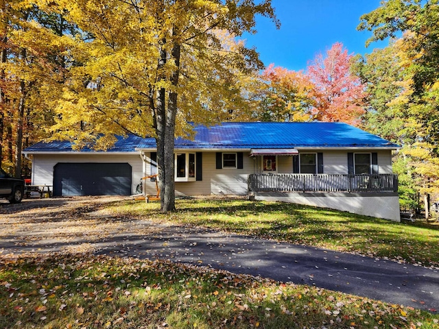 single story home featuring a porch and a garage